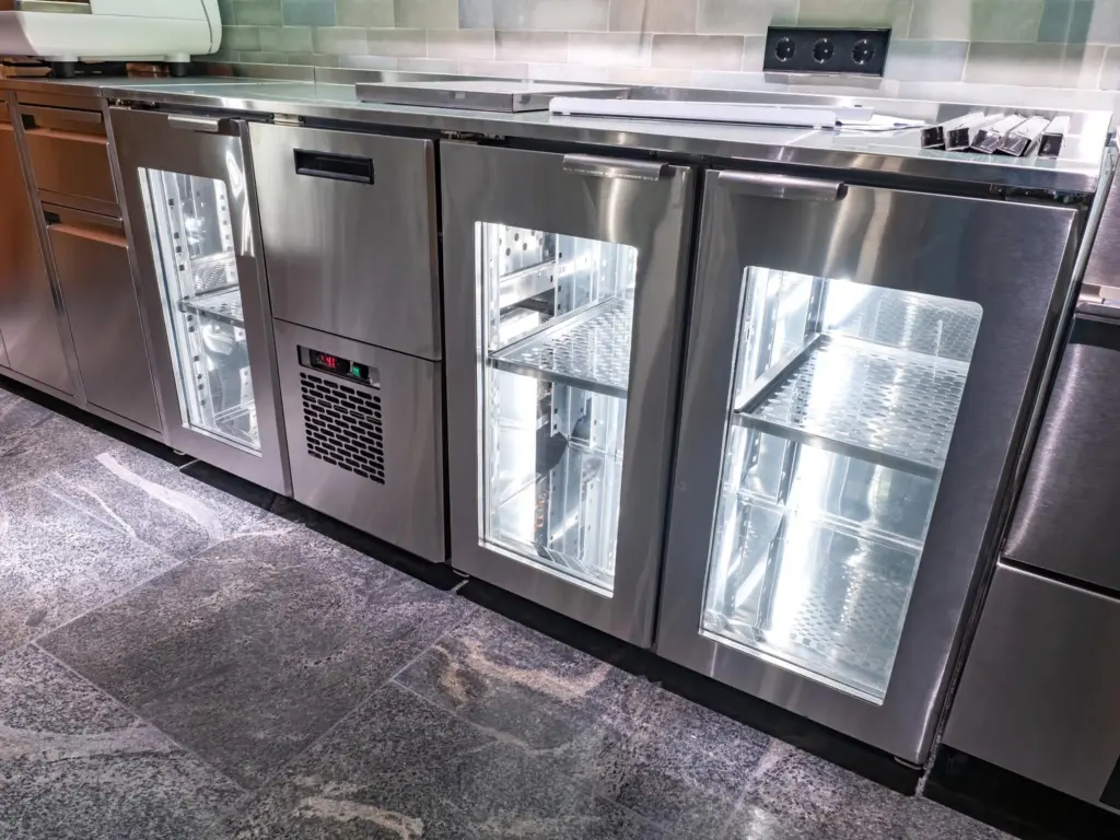 Commercial undercounter glass door refrigerators in a professional kitchen